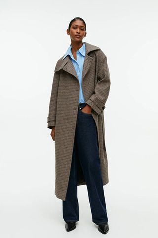 arket sale - woman wearing check print brown wool long coat