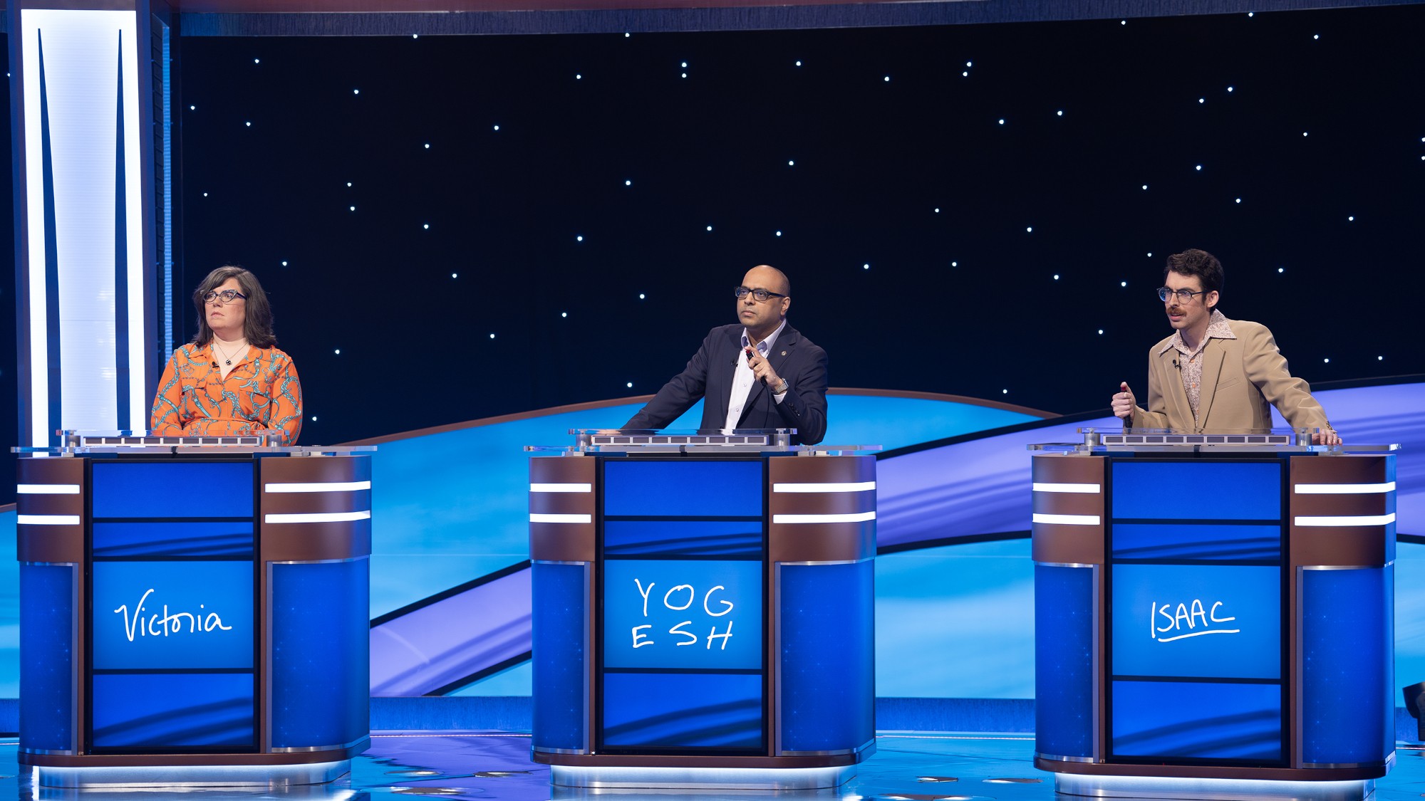 Victoria Groce, Yogesh Raut and Isaac Hirsch behind their podiums on Jeopardy! Masters