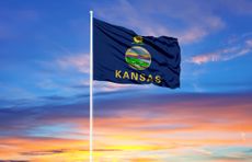Kansas flag on flagpole and blue sky