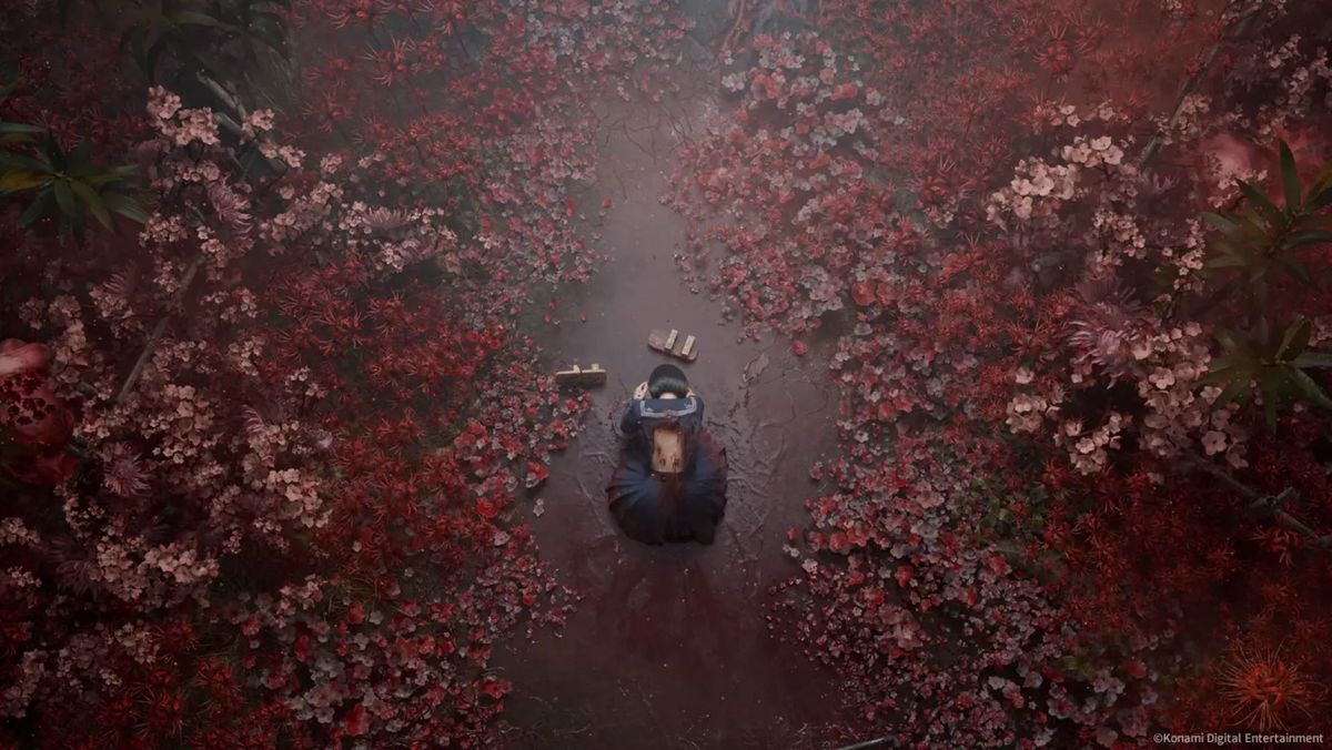 A top down view of a schoolgirl on the floor surrounded by blood-red leaves in Silent Hill f