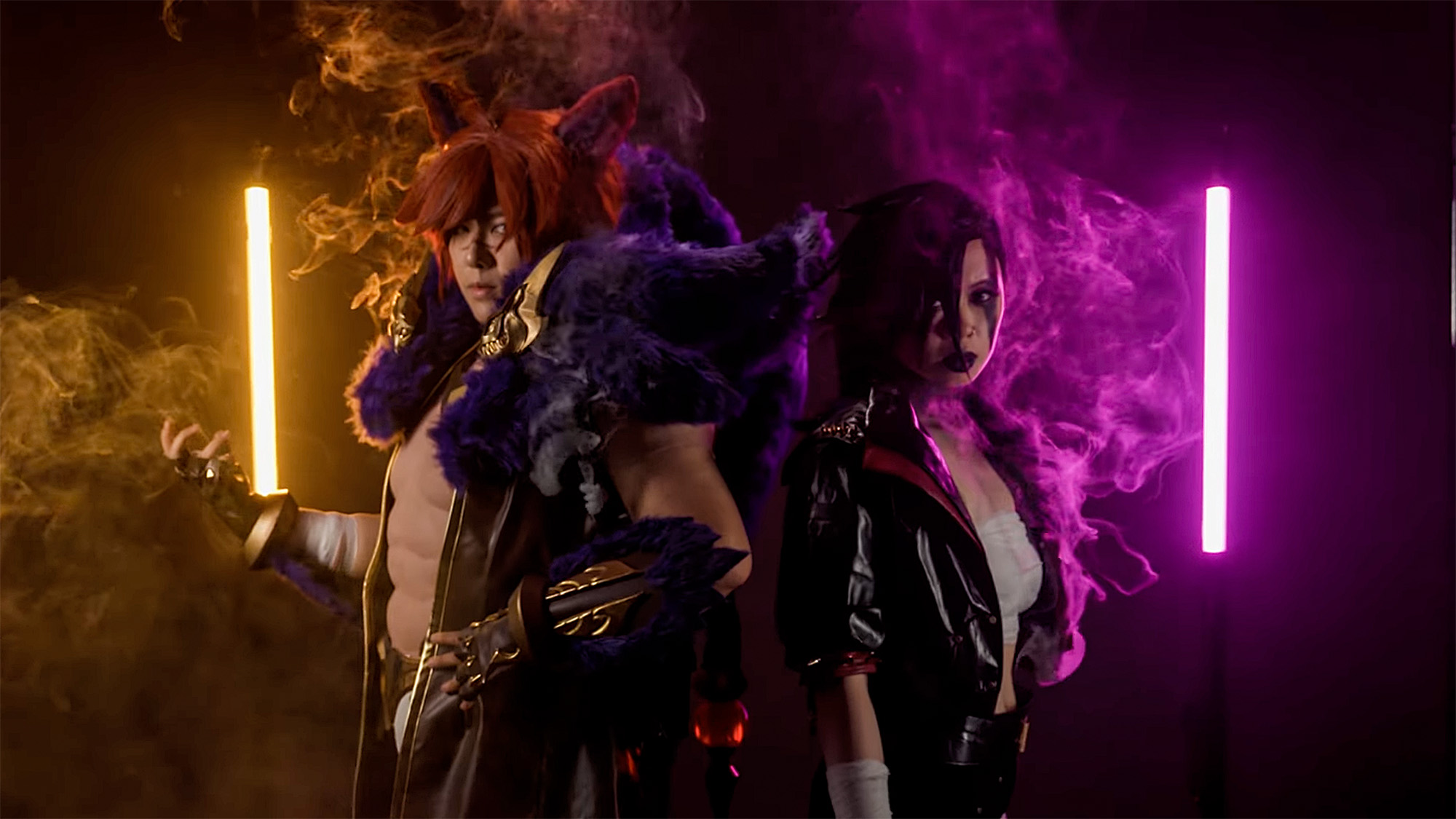 Portrait of two cosplayers in anime-style costumes holding tube lights against a black background with smoke radiating from them via the PMI Smoke Vest 