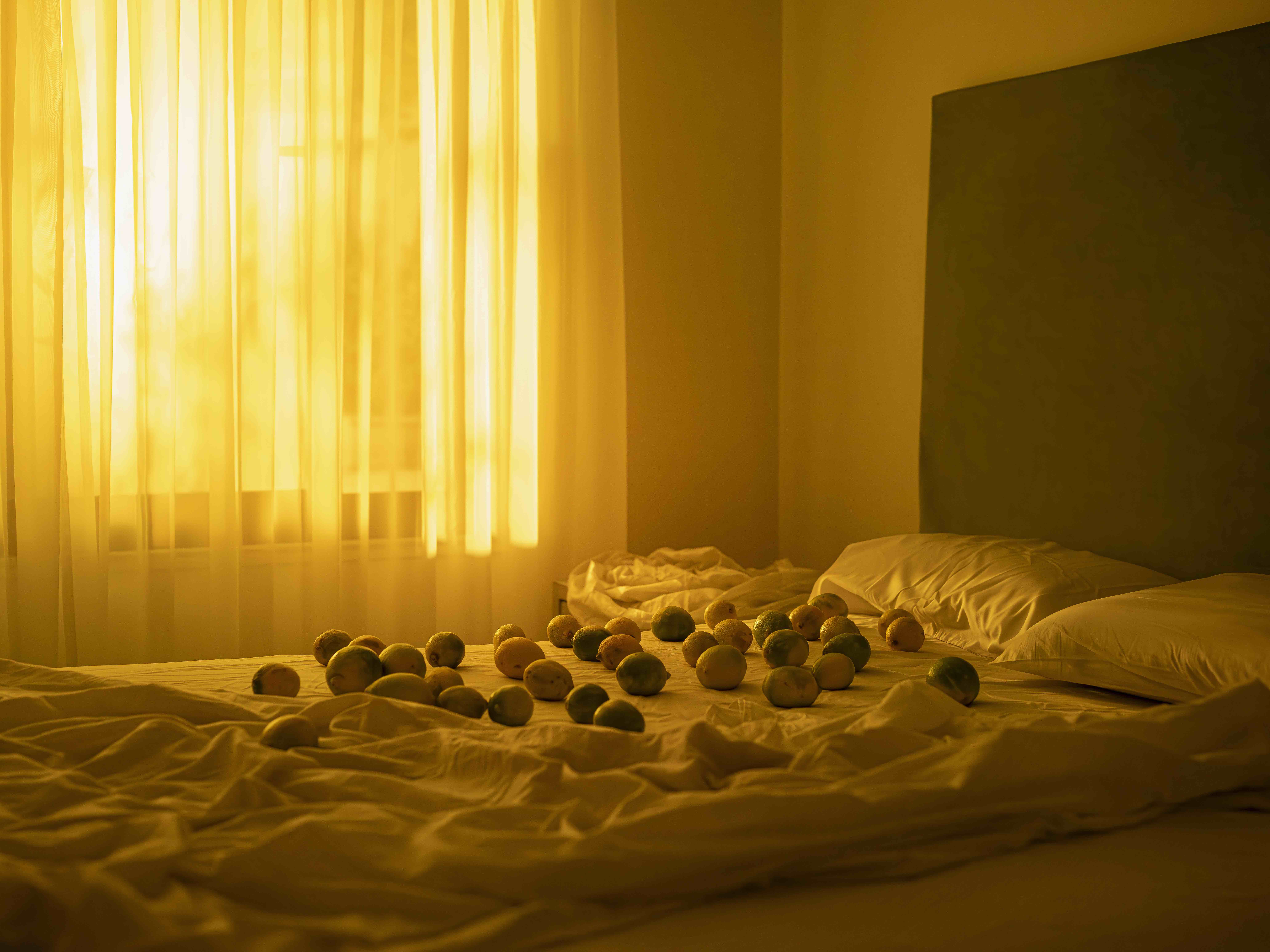 Veuve Clicquot Magnum Photos Emotions of the Sun: balls on bed with sun coming through curtain