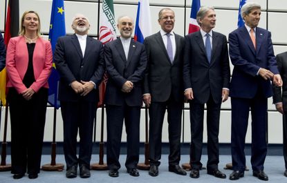 Iranian Foreign Minister Mohammad Javad Zarif laughs.
