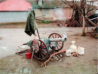 A working cannon made out of recycled materials displayed in an outside setting.