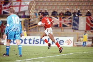 Ian Wright carries the ball back to the halfway line after scoring for England against San Marino in a World Cup qualifier in November 1993.