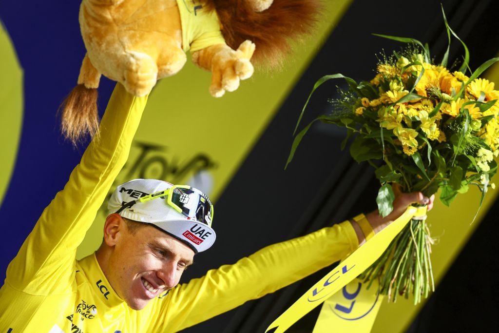 Slovenian Tadej Pogacar of UAE Team Emirates celebrates on the podium in the yellow jersey of leader in the overall ranking after stage 11 of the 2024 Tour de France cycling race, from Evaux-les-Bains to Le Lioran, France (211km) on Wednesday 10 July 2024. The 111th edition of the Tour de France starts on Saturday 29 June and will finish in Nice, France on 21 July. BELGA PHOTO DAVID PINTENS (Photo by DAVID PINTENS / BELGA MAG / Belga via AFP)