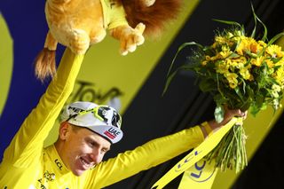Slovenian Tadej Pogacar of UAE Team Emirates celebrates on the podium in the yellow jersey of leader in the overall ranking after stage 11 of the 2024 Tour de France cycling race, from Evaux-les-Bains to Le Lioran, France (211km) on Wednesday 10 July 2024. The 111th edition of the Tour de France starts on Saturday 29 June and will finish in Nice, France on 21 July. BELGA PHOTO DAVID PINTENS (Photo by DAVID PINTENS / BELGA MAG / Belga via AFP)