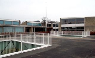 Exterior of school buildings showing light wells in the courtyard to the underground spaces.