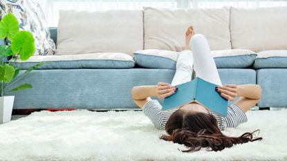 Woman sleeping on the floor with book