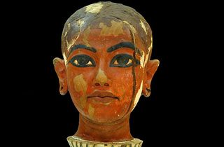 A head statue of Tutankhamun made of wood covered with plaster and then painted.