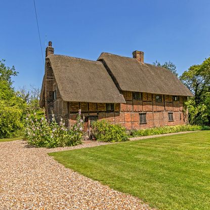sloping roof houses with exposed brick walls and grass lawn