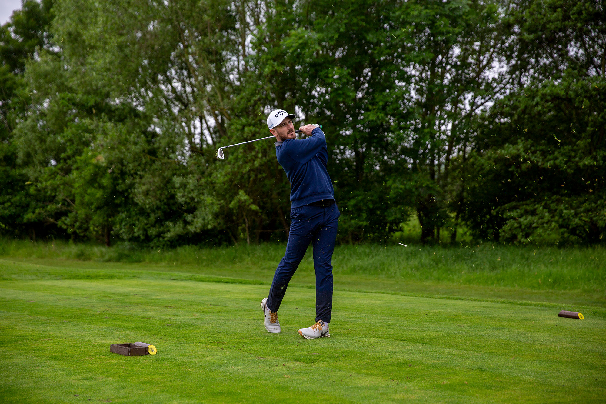 Barry Plummer taking an iron off the tee, in the finish position, in an attempt to find the fairway rather than finding trouble with the driver