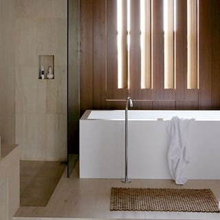 bathroom with white bathtub and towel