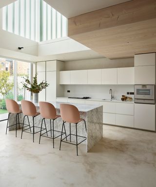 accent colors for a white kitchen, white minimalist kitchen with marble island, peach bar stools, modern extension, marble floor