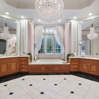 Bathroom with chandelier, wooden units and tiled floor