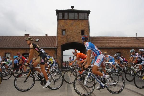 Riders rolll past the site of the Auschwitz concentration camp.
