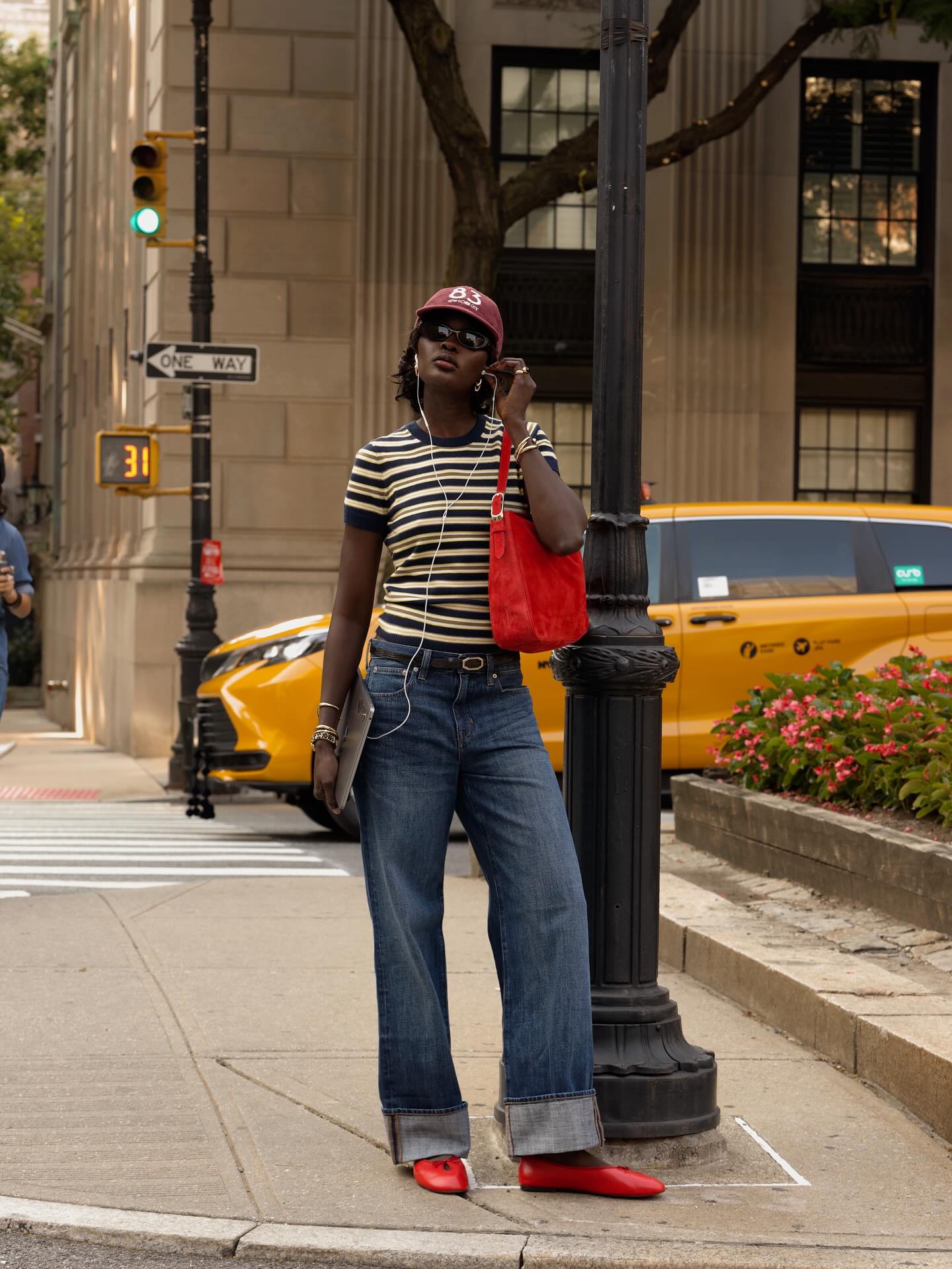 @lefevrediary wears cuffed jeans with a striped crew neck, red suede bag and red tie-up ballet flats.