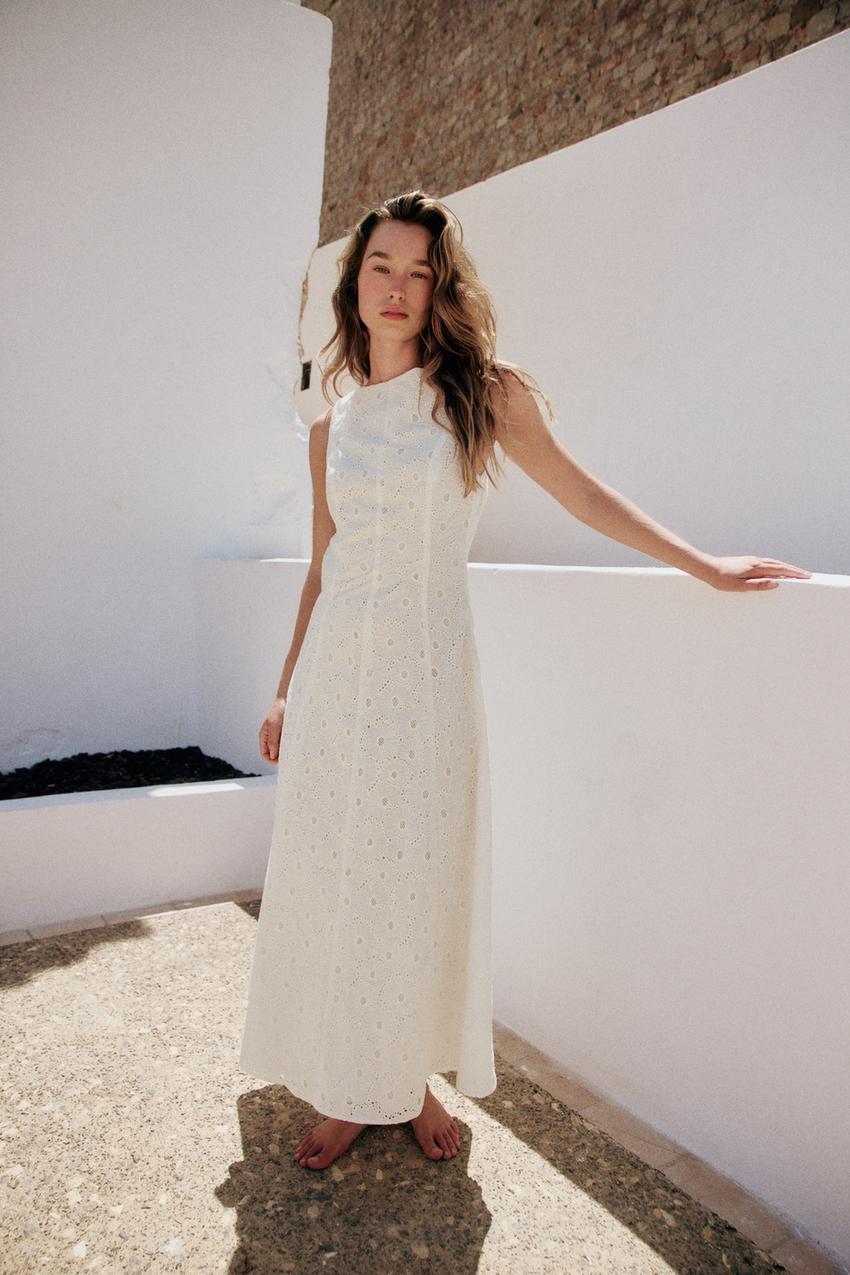 Woman wears white broderie dress
