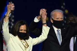 U.S. President-elect Joe Biden and Vice President-elect Kamala Harris stand onstage after delivering remarks in Wilmington, Delaware, on Nov. 7, 2020, after being declared the winners of the presidential election.