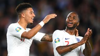 Jadon Sancho and Raheem Sterling celebrate England’s fifth goal against Kosovo