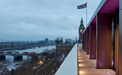 Side view of building and GB flag next to river