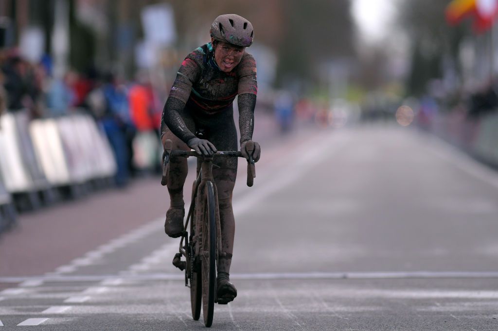 Tiffany Cromwell (Canyon-SRAM) caked in mud as she crosses the line