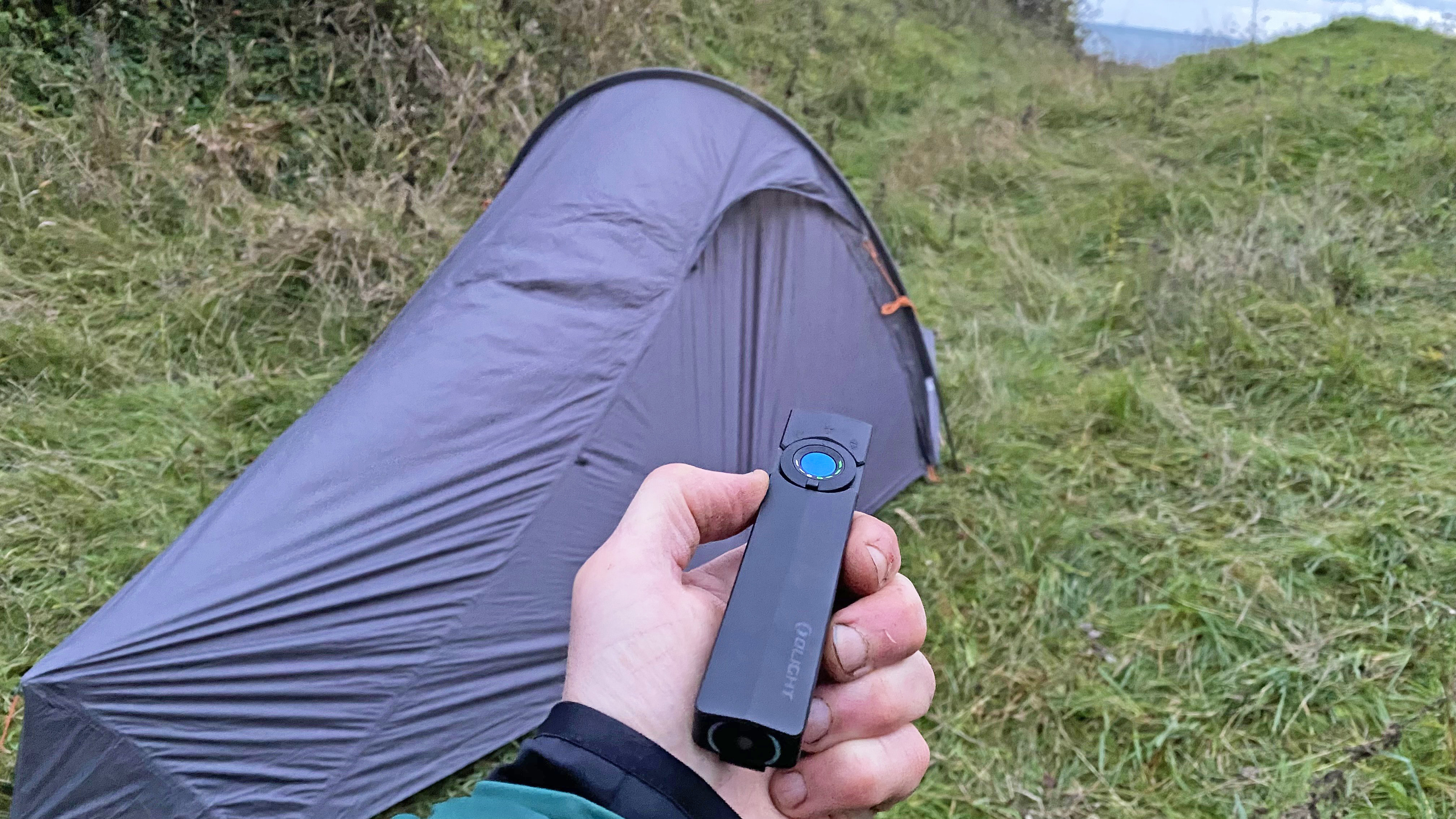 A camper using the Olight ArkPro flashlight