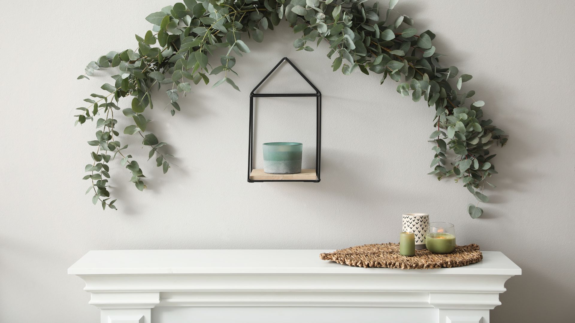 picture of fireplace with decor and arch of eucalyptus