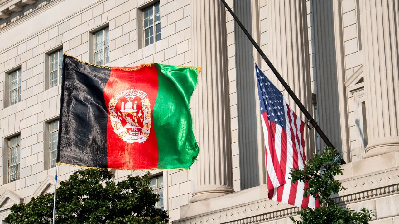 An Afghanistan flag is seen waving in front of a US flag on 28 August 2021 in Washington, DC 