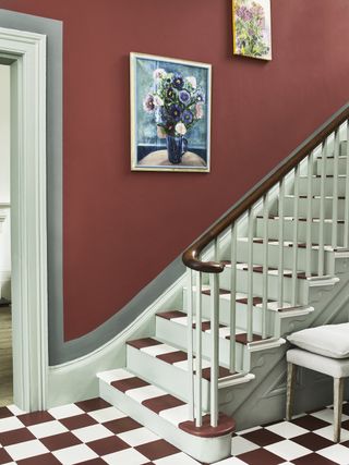 Victorian-style red hallway with painted floor and stairway