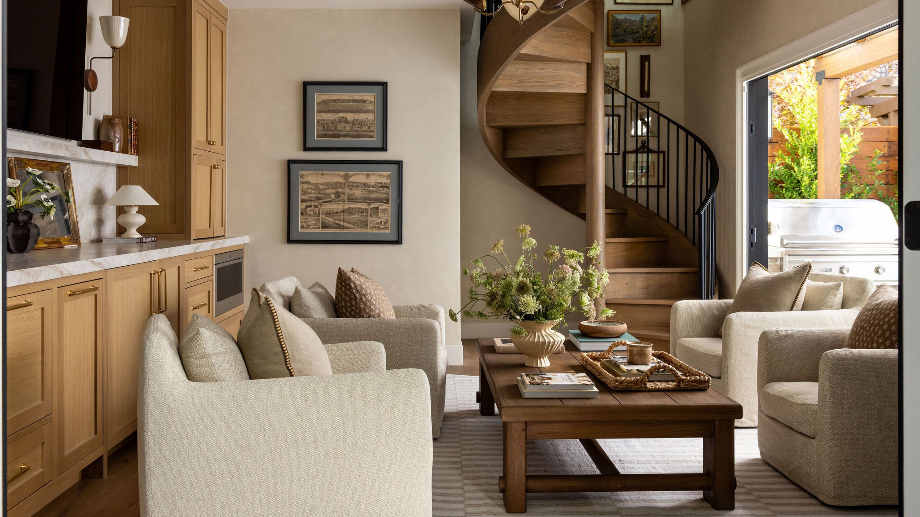 a large ADU with wooden spiral staircase, an oak kitchenette and small layered sitting area