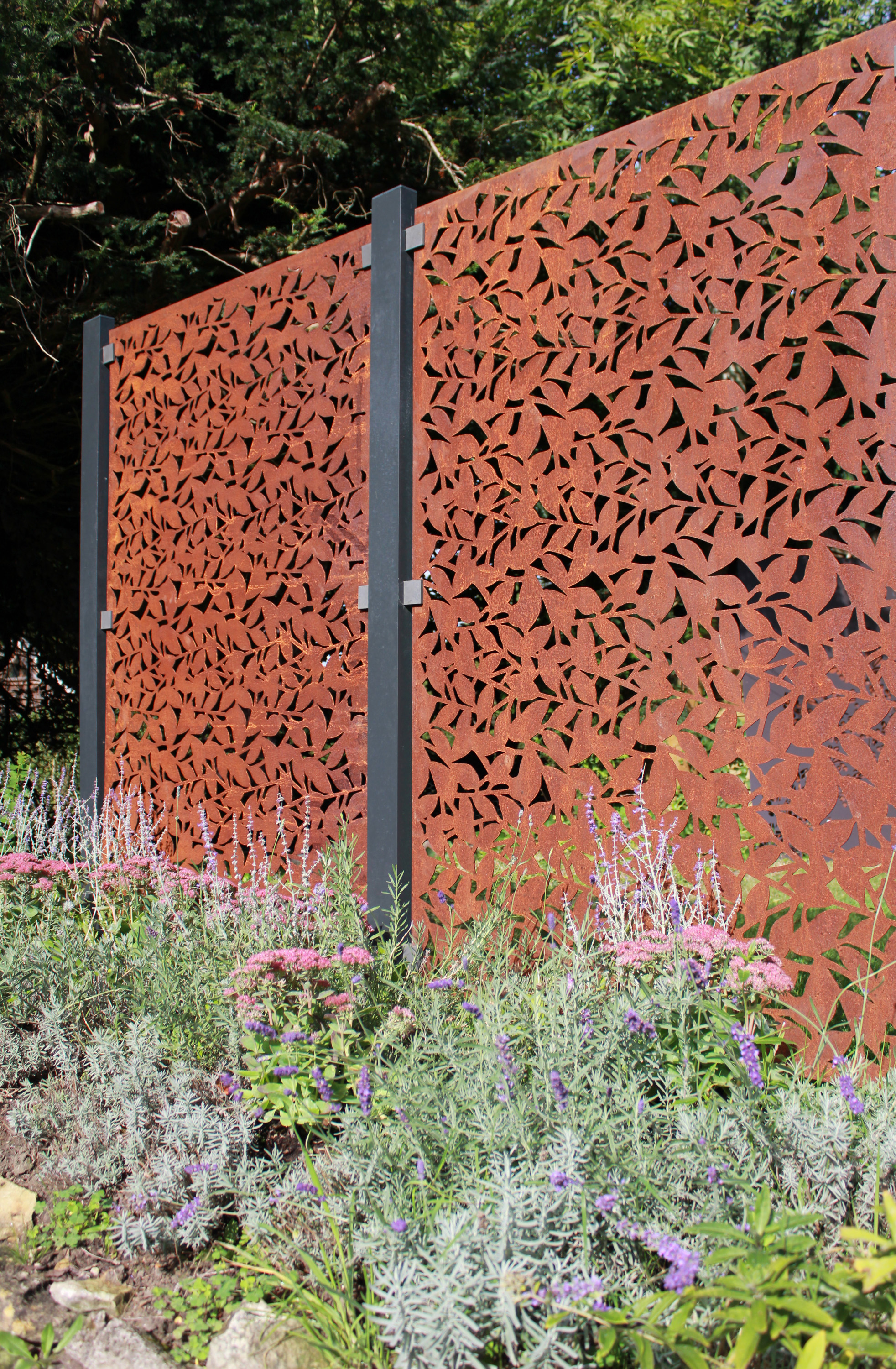 metal fretwork panels used as a garden wall