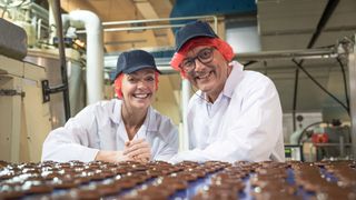 Gregg Wallace and Cherry Healey wearing white coats for Inside the Factory 2023