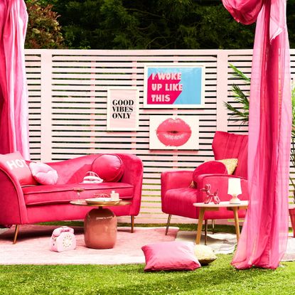 pink barbiecore garden party with pergola and pink sofa and armchair