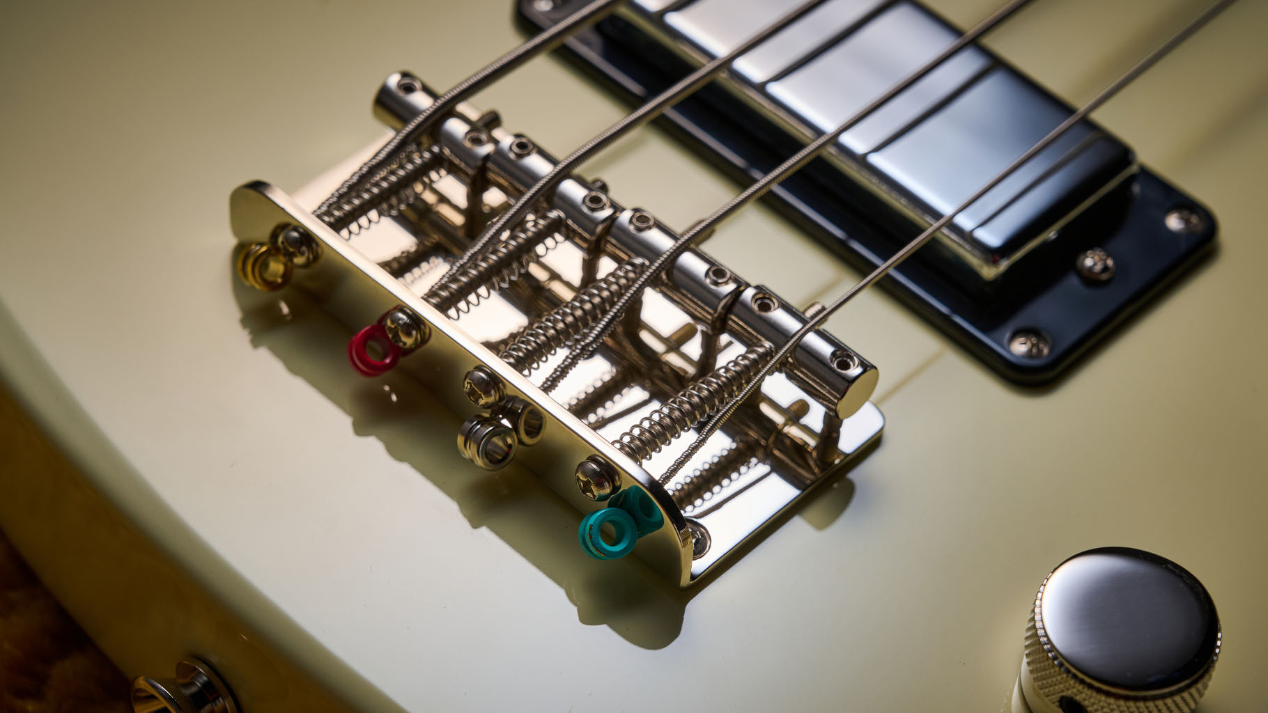 Gretsch Electromatic CVT Bass Double-cut: the retro-styled cream-colored four-string is pictured in close-up against a shaggy brown carpet.