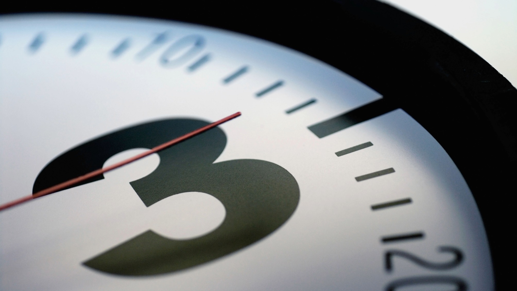 Close-up of the second hand of a clock on number three 