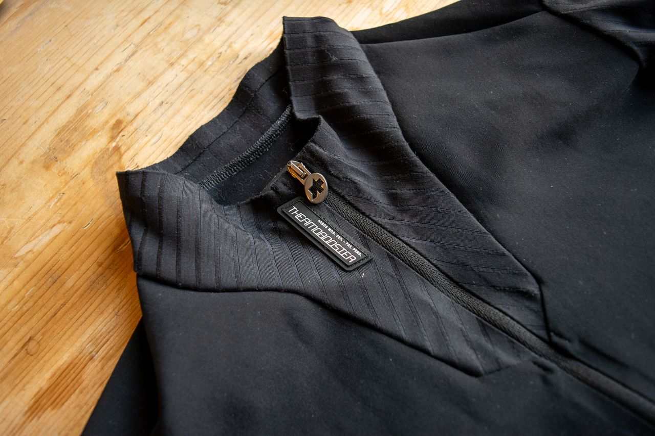 A black Thermobooster base layer on a wooden table