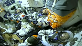 The Shenzhou 15 crew inside the cabin during launch.