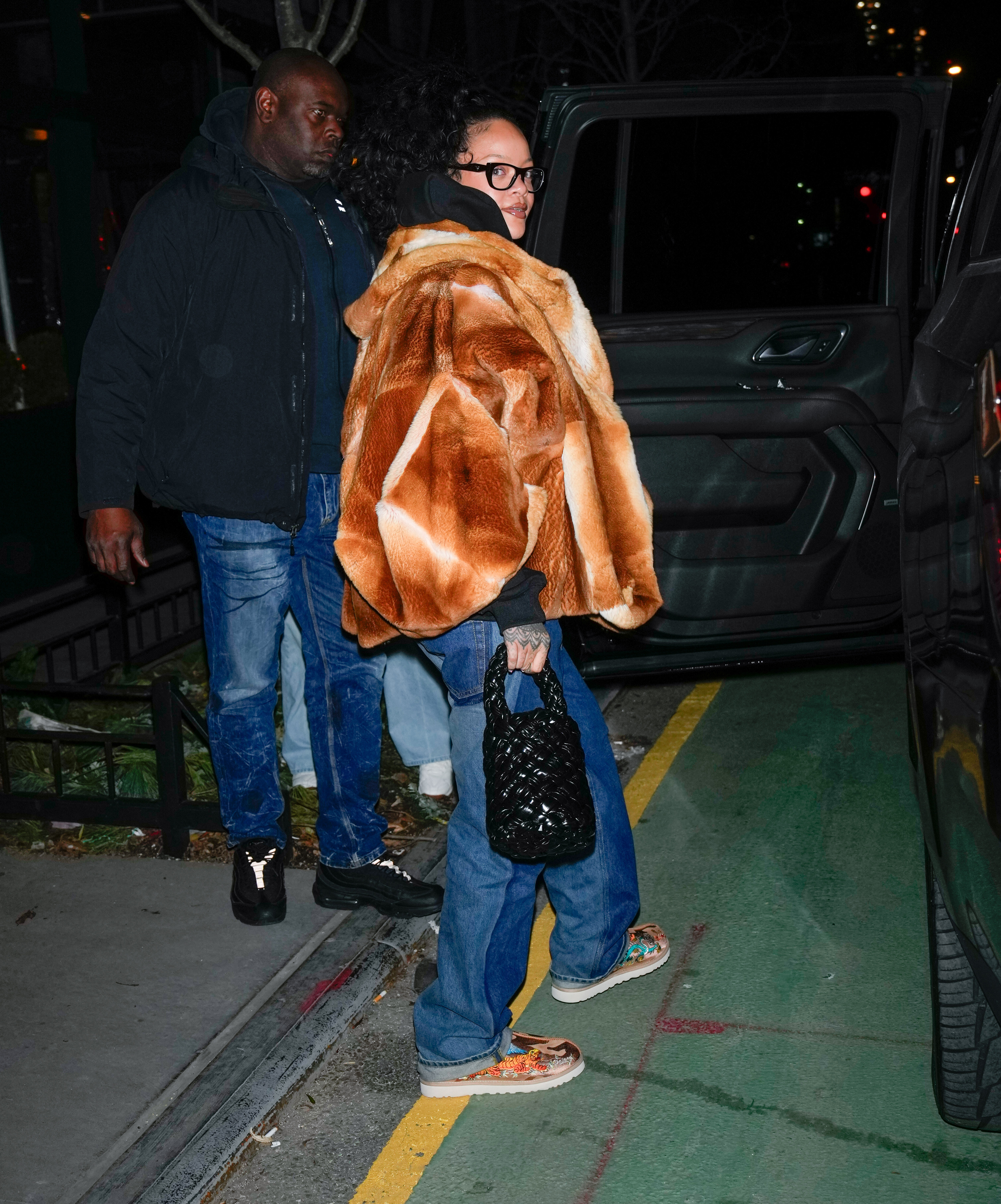 Rihanna in Ugg slippers and fur coats is seen on January 2, 2025 in New York City