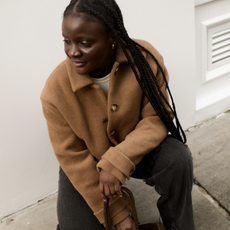 Brittany Davy wears cow print trainers with a wool jacket and jeans.