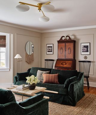 Cream, neutral living room with green velvet sofa