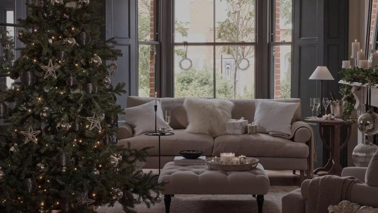 artificial christmas trees in a cosy living room