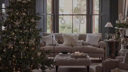 artificial christmas trees in a cosy living room