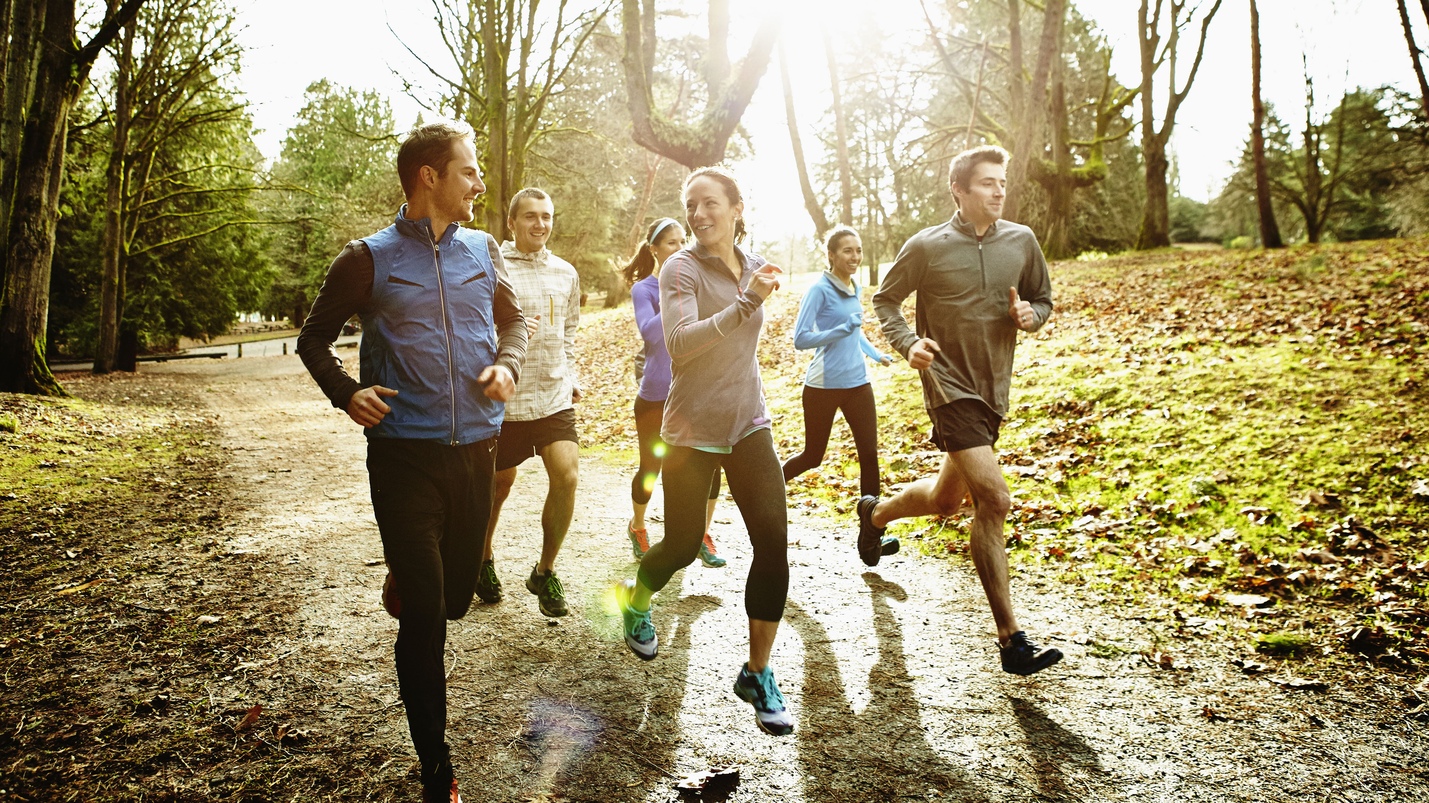 A group of young people running together in the park