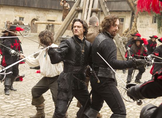 THE THREE MUSKETEERS - LOGAN LERMAN (white shirt), LUKE EVANS, RAY STEVENSON (back to camera) and MATTHEW MACFADYEN