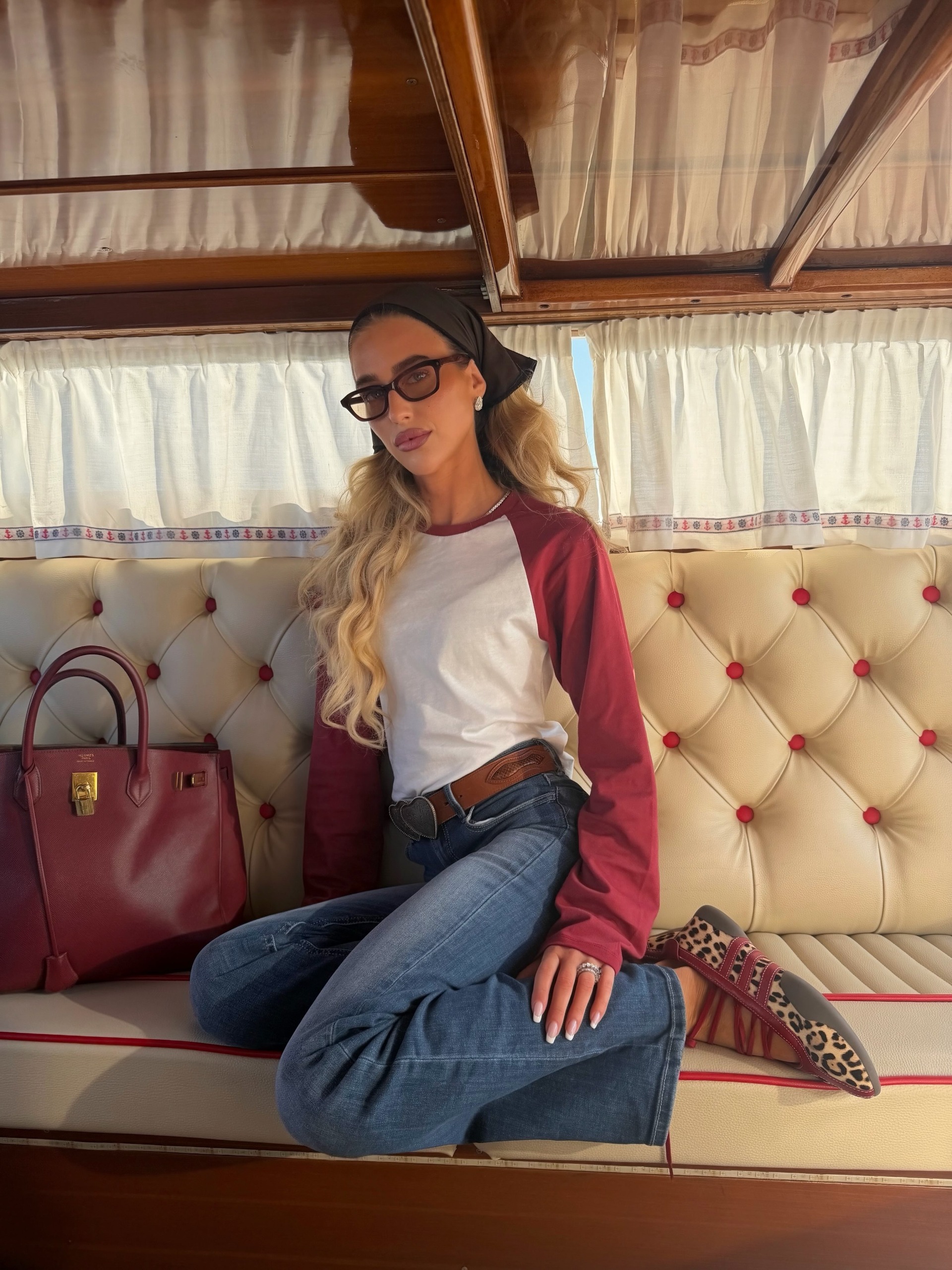 Influencer wearing a baseball tee with jeans and leopard flats