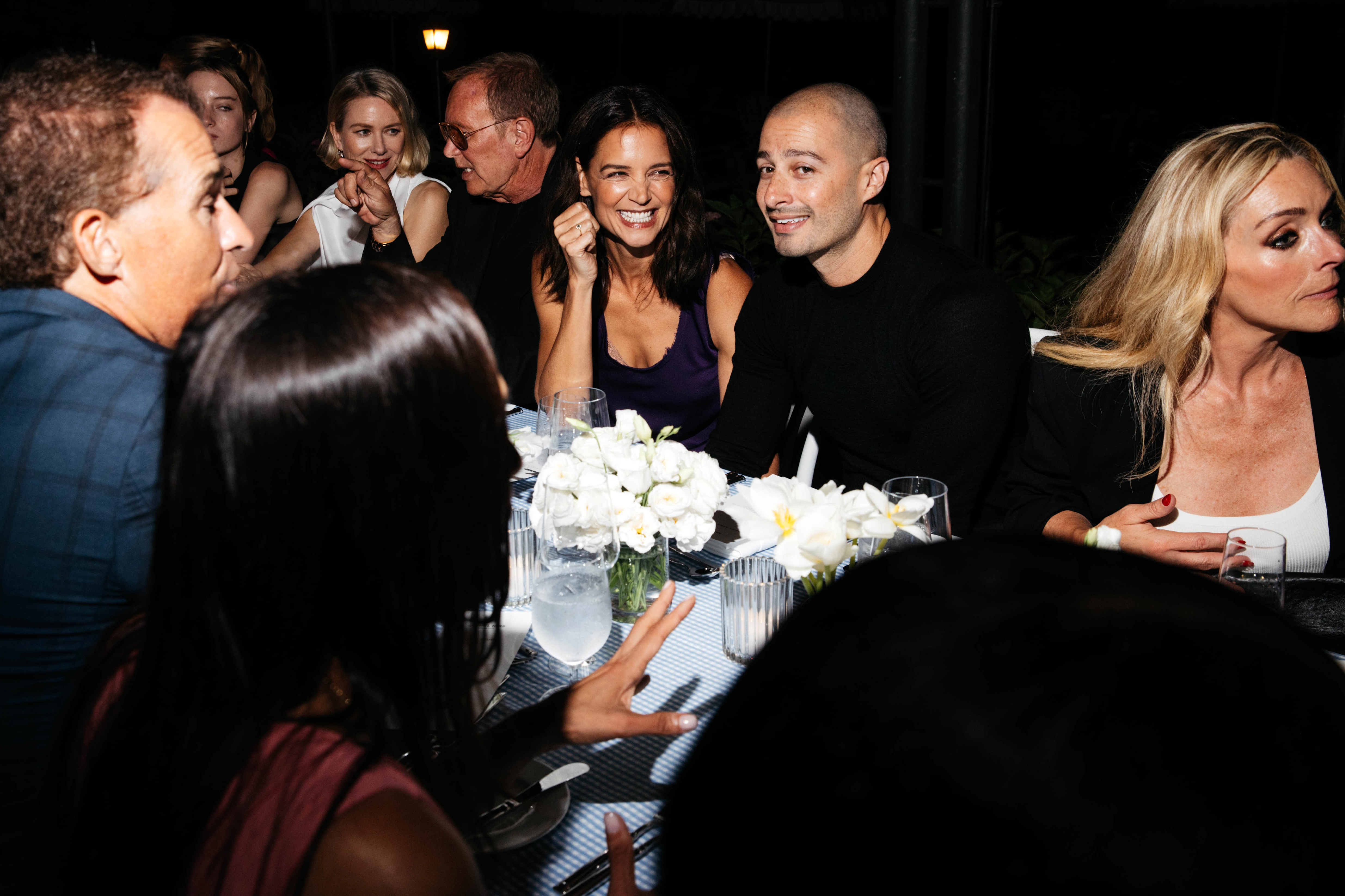 Katie Holmes wearing a purple dress and red shoes at the Michael Kors 45th Anniversary Collection Dinner held at Swifty's at The Hedges Inn on August 20, 2026 in East Hampton, New York