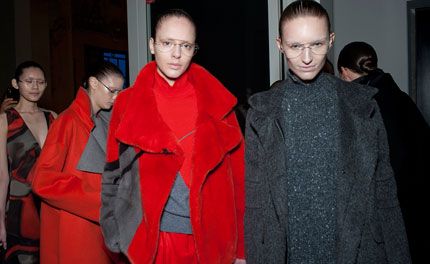 Two female models wearing red and grey fur coats