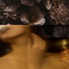 woman applying perfume with moody flowers