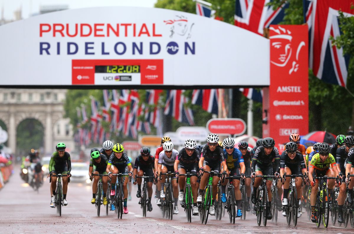 The peloton passes under the start/finish arch